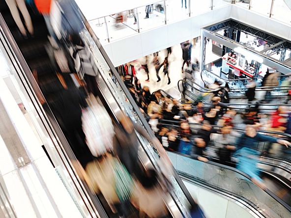 motion blurred picture of people in a shopping mall escalator